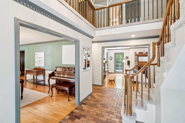 319 Powder Mill Dr, Ashland City, TN 37015 - foyer entrance with crown molding, baseboards, brick floor, and stairway