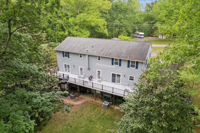 319 Powder Mill Dr, Ashland City, TN 37015 - rear view of house featuring roof with shingles, a wooden deck, central AC unit, a wooded view, and stairs