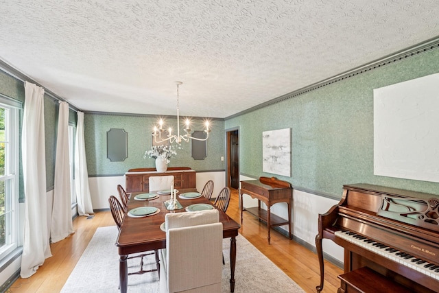 319 Powder Mill Dr, Ashland City, TN 37015 - dining room featuring a chandelier, wallpapered walls, a textured ceiling, and wood finished floors