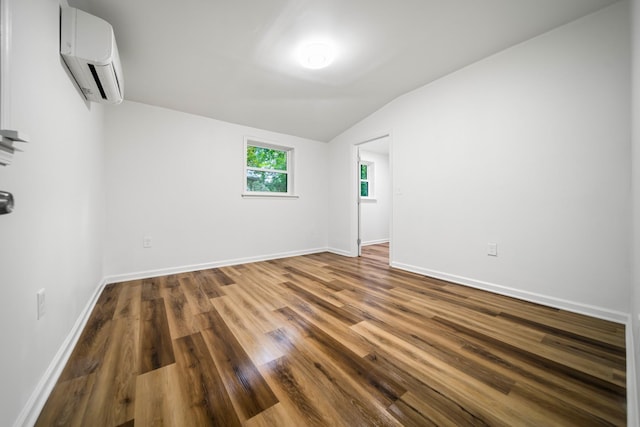 27 Cameo Dr, Nashville, TN 37211 - unfurnished room with baseboards, a wall mounted air conditioner, lofted ceiling, and wood finished floors