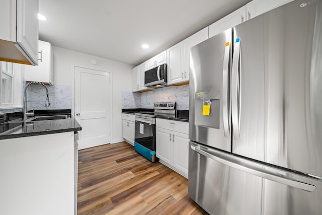 27 Cameo Dr, Nashville, TN 37211 - kitchen featuring white cabinets, appliances with stainless steel finishes, decorative backsplash, and a sink