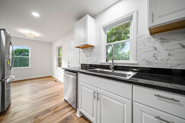 27 Cameo Dr, Nashville, TN 37211 - kitchen featuring appliances with stainless steel finishes, a sink, white cabinetry, decorative backsplash, and light wood-type flooring