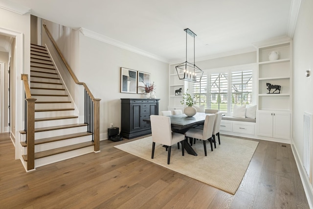 121 Dylan Woods Dr, Nolensville, TN 37135 - dining area with crown molding, stairway, baseboards, wood-type flooring, and a chandelier