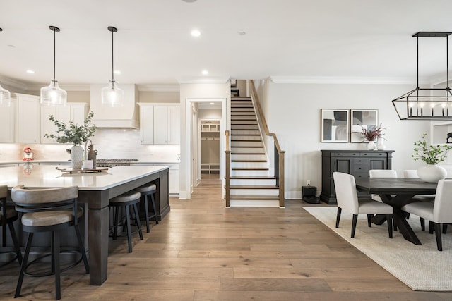 121 Dylan Woods Dr, Nolensville, TN 37135 - kitchen with decorative backsplash, white cabinetry, a breakfast bar, and light countertops