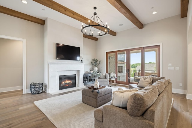 121 Dylan Woods Dr, Nolensville, TN 37135 - living room featuring beam ceiling, a glass covered fireplace, recessed lighting, baseboards, and wood finished floors