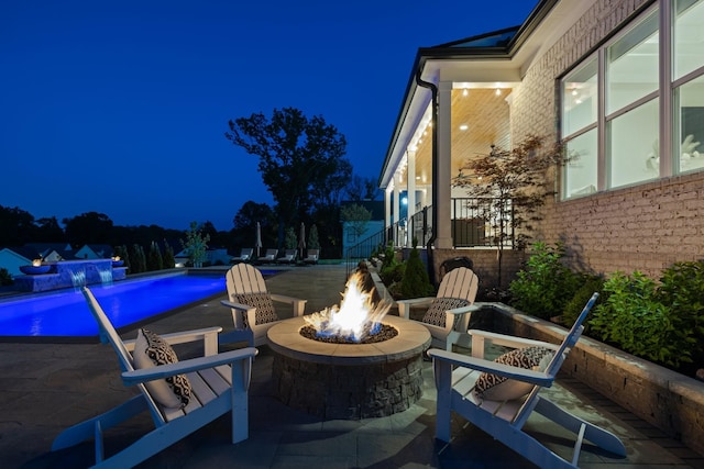 121 Dylan Woods Dr, Nolensville, TN 37135 - patio at twilight featuring a fire pit and an outdoor pool