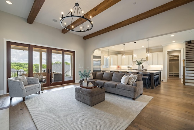 121 Dylan Woods Dr, Nolensville, TN 37135 - living room with a notable chandelier, beam ceiling, arched walkways, recessed lighting, and wood finished floors