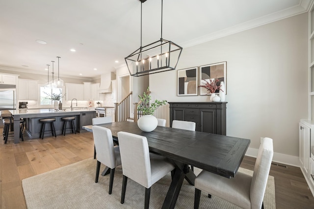 121 Dylan Woods Dr, Nolensville, TN 37135 - dining area with recessed lighting, a chandelier, ornamental molding, and light wood-type flooring