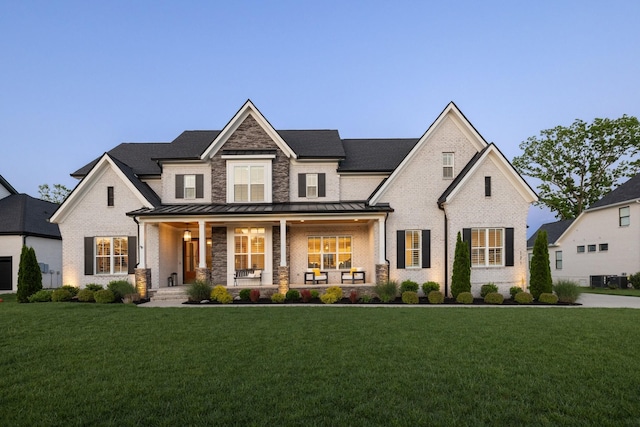121 Dylan Woods Dr, Nolensville, TN 37135 - modern farmhouse with brick siding, a front lawn, covered porch, and a standing seam roof