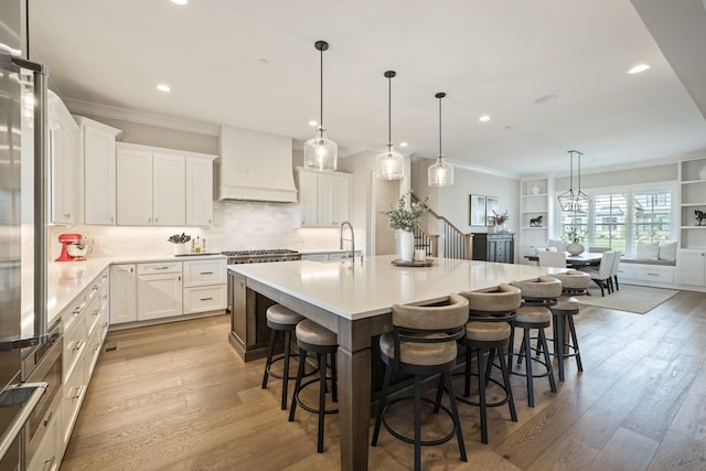 121 Dylan Woods Dr, Nolensville, TN 37135 - kitchen featuring a sink, ornamental molding, custom range hood, and light wood-style flooring