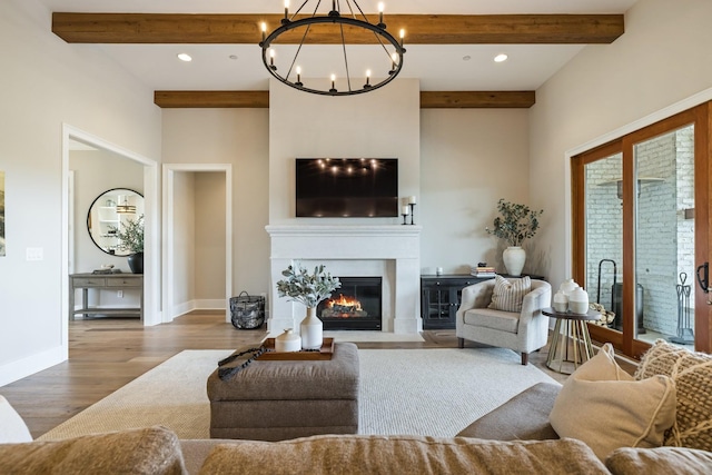 121 Dylan Woods Dr, Nolensville, TN 37135 - living room featuring a notable chandelier, beam ceiling, recessed lighting, a fireplace with flush hearth, and wood finished floors