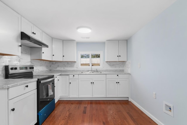 kitchen with decorative backsplash, a sink, electric stove, under cabinet range hood, and dark wood-type flooring