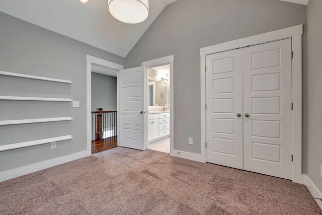 503B Acklen Park Dr, Nashville, TN 37205 - unfurnished bedroom with light colored carpet, baseboards, ensuite bathroom, lofted ceiling, and a closet