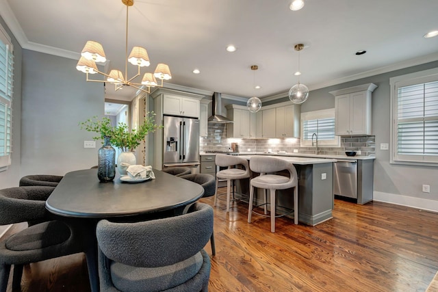 503B Acklen Park Dr, Nashville, TN 37205 - kitchen featuring crown molding, appliances with stainless steel finishes, a chandelier, a center island, and tasteful backsplash