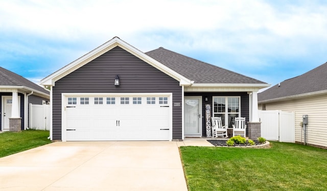 single story home with fence, an attached garage, driveway, and a front lawn