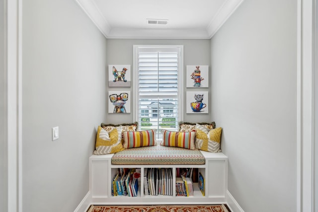 mudroom featuring baseboards, crown molding, and visible vents