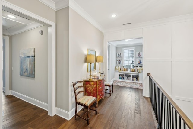 hallway with dark wood-type flooring, ornamental molding, baseboards, and recessed lighting