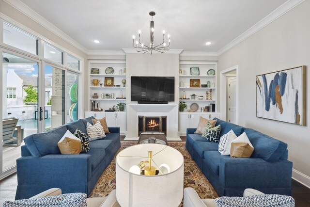living room with a notable chandelier, built in features, baseboards, a fireplace with flush hearth, and ornamental molding