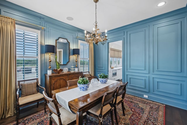 dining area featuring an inviting chandelier, a wealth of natural light, and a decorative wall