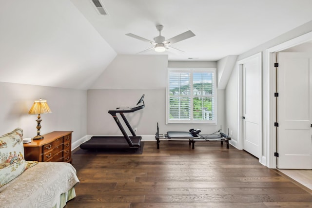 bedroom featuring a ceiling fan, visible vents, vaulted ceiling, wood finished floors, and baseboards
