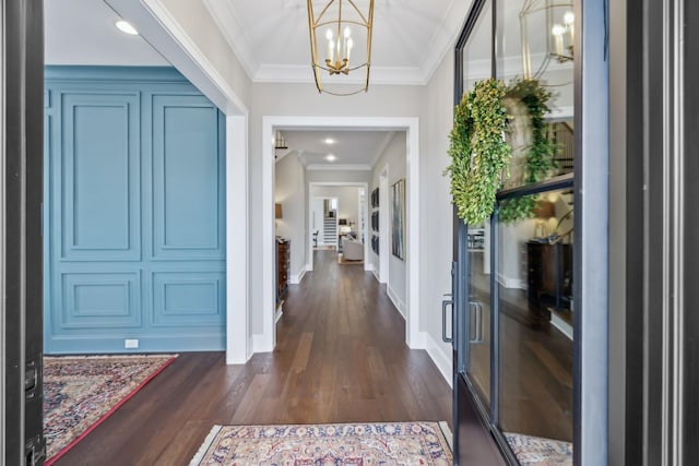 entrance foyer featuring french doors, dark wood finished floors, baseboards, an inviting chandelier, and ornamental molding