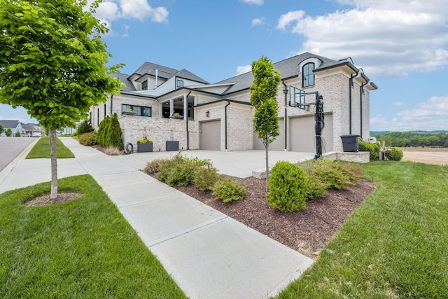 view of front of property with brick siding, a front yard, and concrete driveway