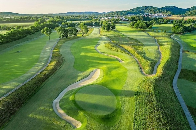 aerial view featuring view of golf course and a mountain view