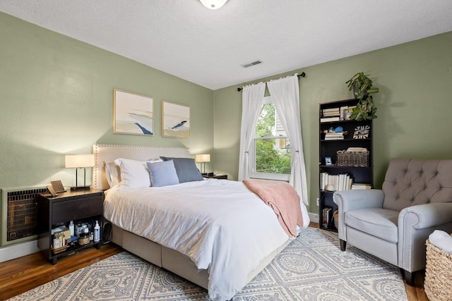 3610 Gleason Dr, Chattanooga, TN 37412 - bedroom featuring heating unit, baseboards, wood finished floors, and visible vents