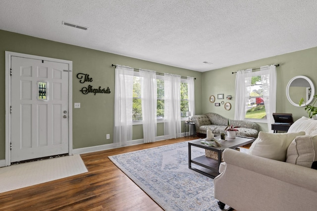 3610 Gleason Dr, Chattanooga, TN 37412 - living room featuring visible vents, baseboards, a textured ceiling, and wood finished floors