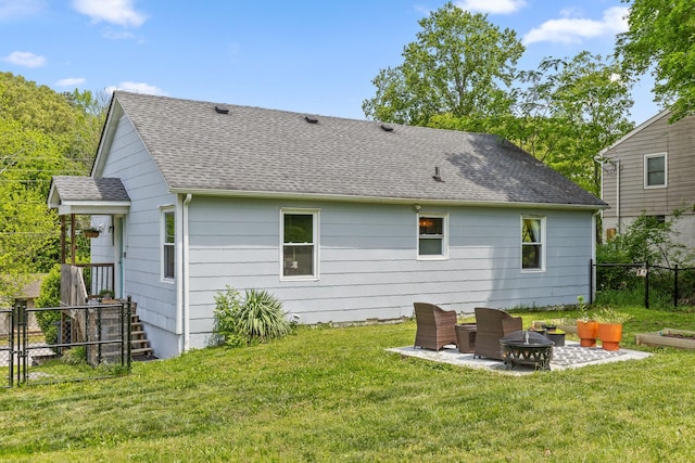 3610 Gleason Dr, Chattanooga, TN 37412 - rear view of property featuring a patio, a fenced backyard, a shingled roof, a lawn, and an outdoor fire pit