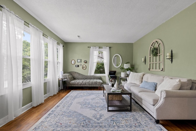 3610 Gleason Dr, Chattanooga, TN 37412 - living area featuring a textured ceiling, radiator, baseboards, wood finished floors, and visible vents