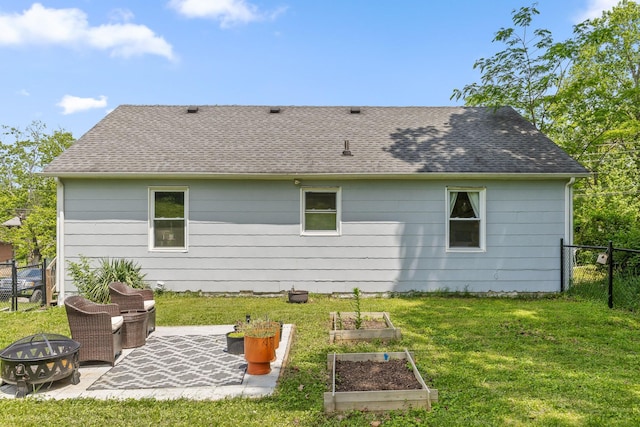 3610 Gleason Dr, Chattanooga, TN 37412 - rear view of property with fence, roof with shingles, an outdoor fire pit, a garden, and a yard