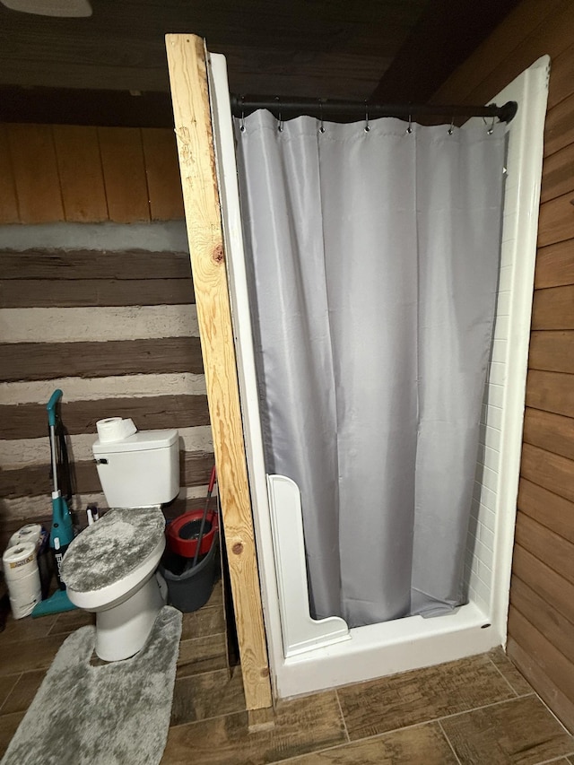 8901 Primm Springs Rd, Primm Springs, TN 38476 - bathroom featuring toilet, a shower stall, and wood walls