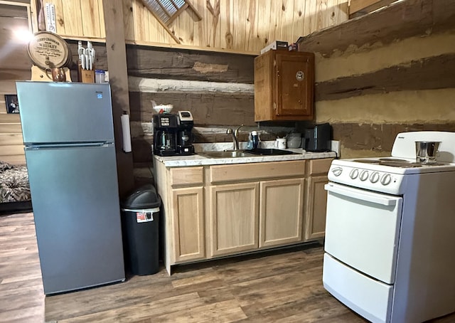 8901 Primm Springs Rd, Primm Springs, TN 38476 - kitchen with freestanding refrigerator, white electric stove, a sink, wood finished floors, and light countertops