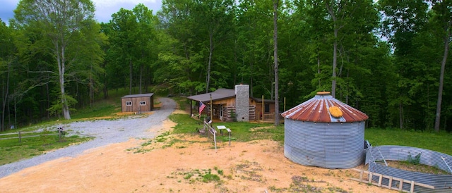 8901 Primm Springs Rd, Primm Springs, TN 38476 - view of yard with an outdoor structure, a shed, and a view of trees