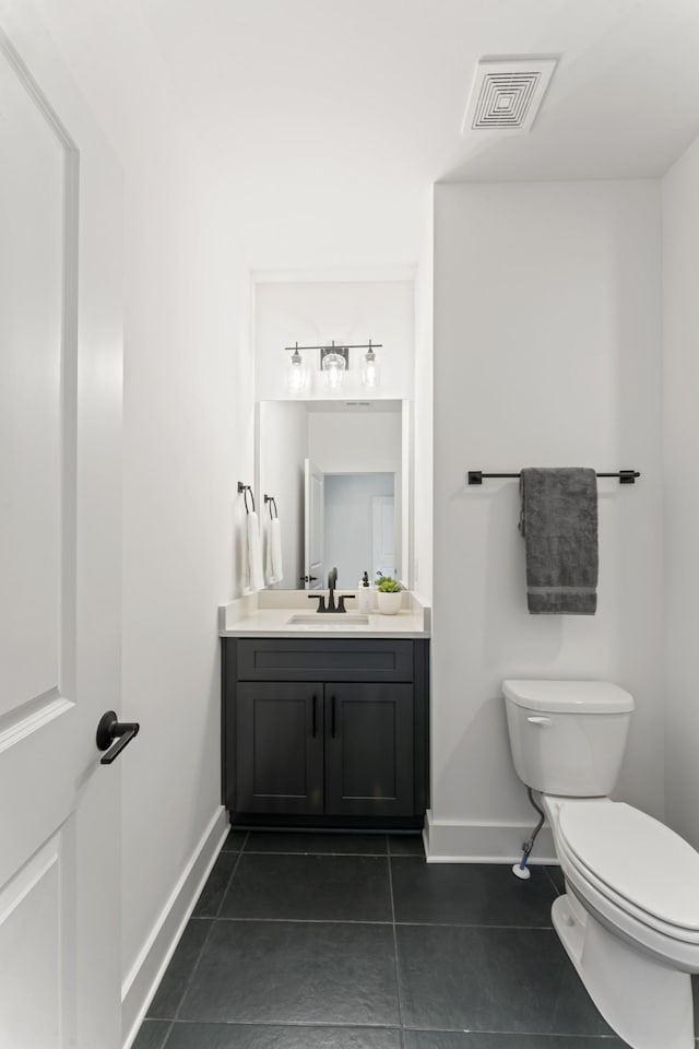 half bath with vanity, toilet, tile patterned floors, baseboards, and visible vents