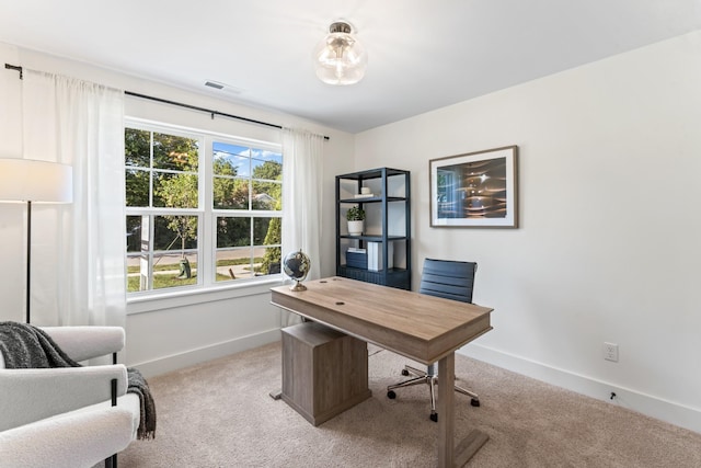 home office featuring baseboards, visible vents, and light colored carpet