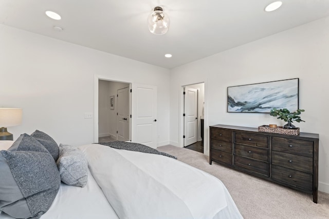 bedroom with baseboards, recessed lighting, and light colored carpet