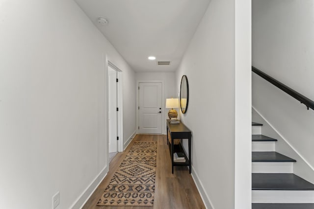 corridor featuring visible vents, wood finished floors, stairway, baseboards, and recessed lighting