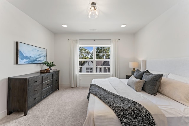 bedroom with light colored carpet, recessed lighting, baseboards, and visible vents