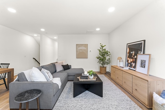 living area featuring recessed lighting, baseboards, and light wood-style floors