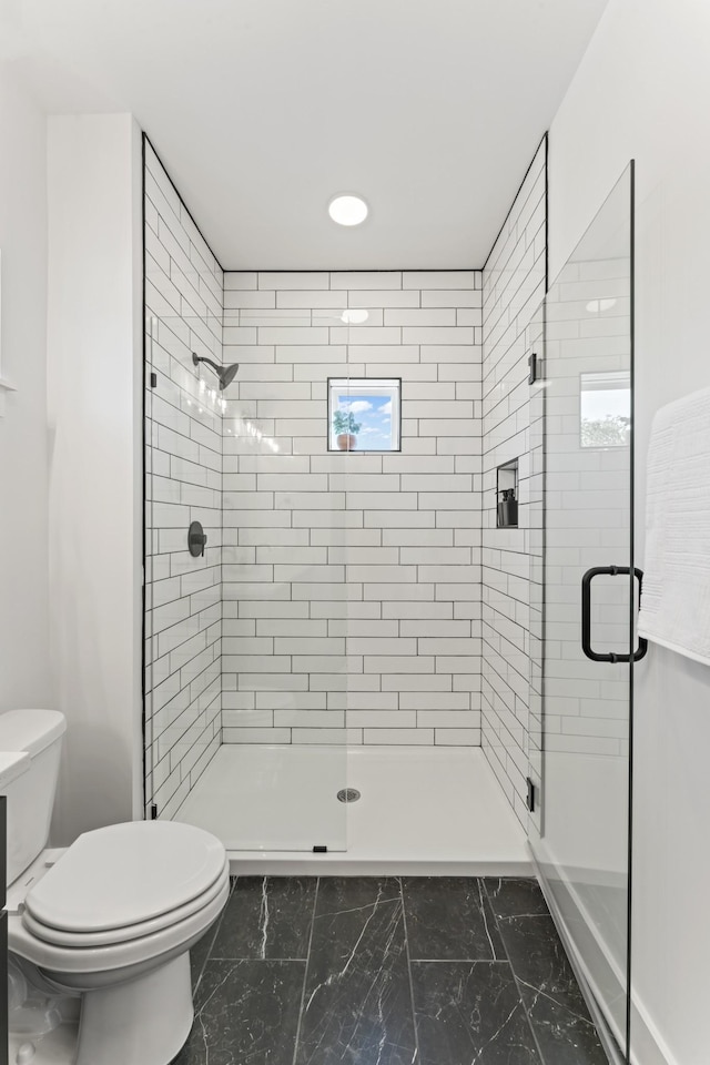 full bath with toilet, a shower stall, and marble finish floor