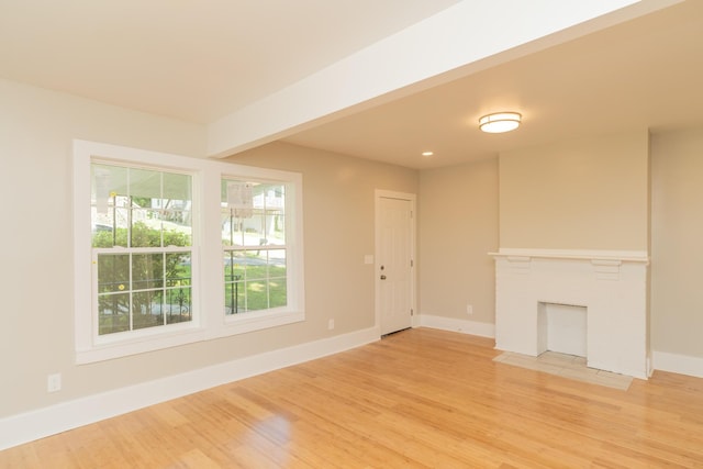 716 Larkin Ave, Chattanooga, TN 37411 - unfurnished living room featuring baseboards, recessed lighting, a fireplace with flush hearth, and light wood-type flooring