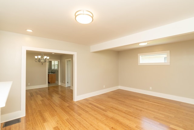 716 Larkin Ave, Chattanooga, TN 37411 - spare room with a chandelier, visible vents, light wood-style flooring, and a healthy amount of sunlight