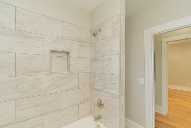 716 Larkin Ave, Chattanooga, TN 37411 - bathroom with baseboards, bathtub / shower combination, and wood finished floors