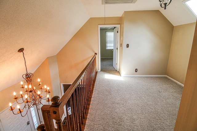 additional living space featuring carpet floors, baseboards, a chandelier, and lofted ceiling
