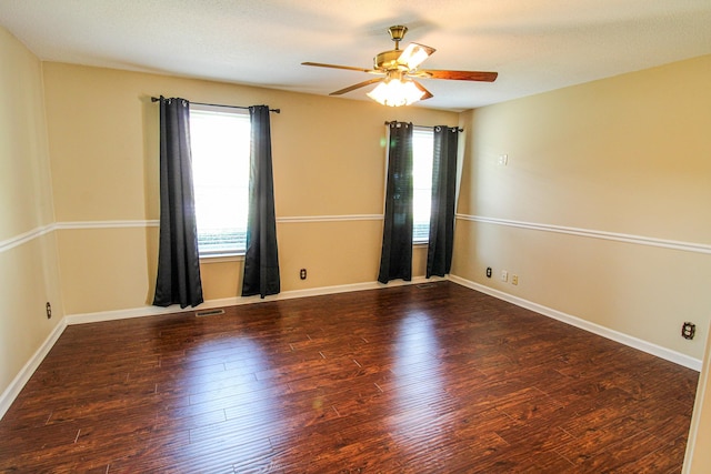 unfurnished room with ceiling fan, a healthy amount of sunlight, and wood finished floors