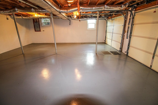 below grade area featuring concrete block wall and electric panel