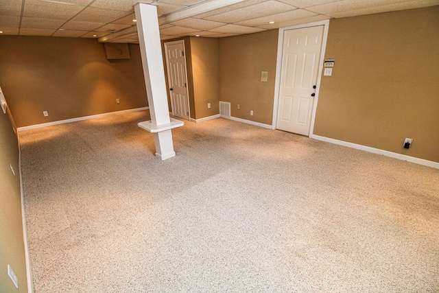 finished below grade area featuring baseboards, carpet floors, a paneled ceiling, and visible vents