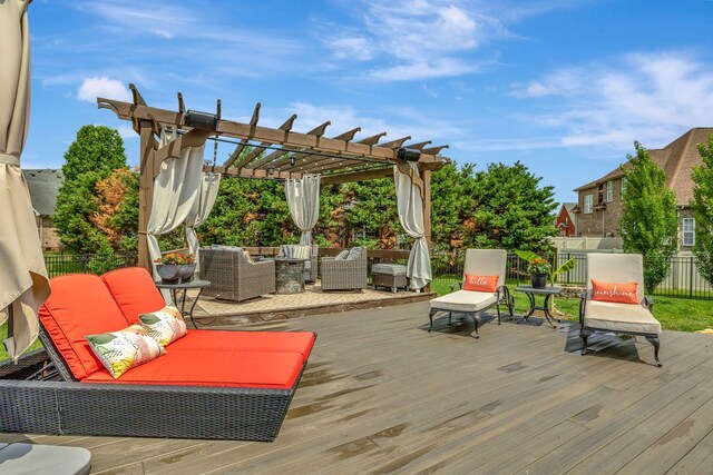 wooden deck with an outdoor hangout area, fence, and a pergola